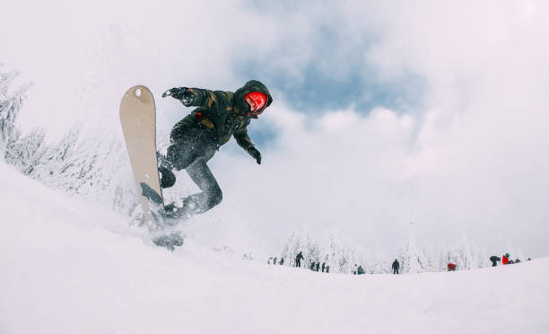 istock Action Shot Of A Young Man On A Snowboard 1289705193