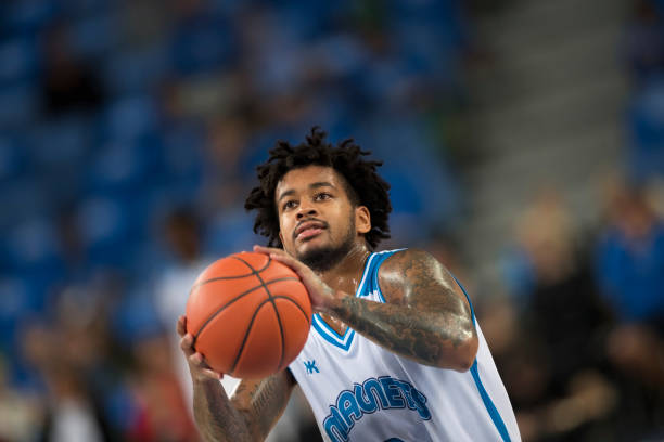 istock Basketball player throwing basketball 1289707290