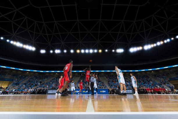 istock Basketball players playing on court 1289707310