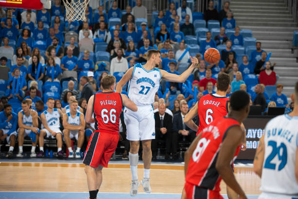 istock Basketball players chasing for ball 1289707312