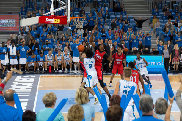 istock Basketball players chasing for ball 1289707353