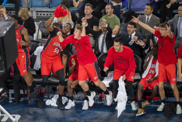 istock Basketball players cheering in stadium 1289707362