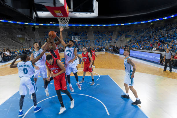 istock Basketball player jumping to score slam dunk 1289707364