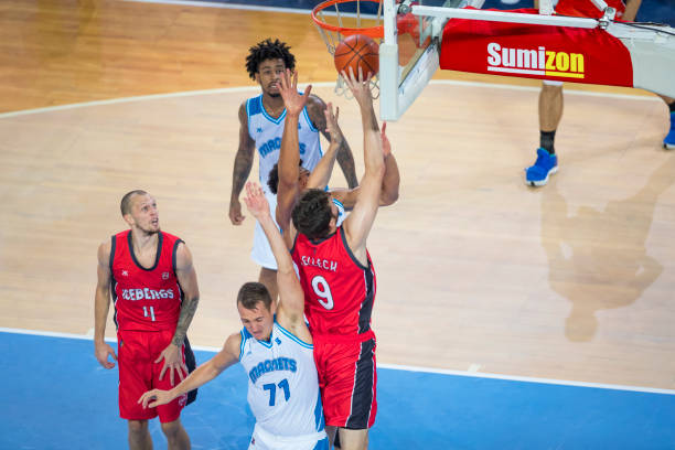 istock Basketball player jumping to score slam dunk 1289707369