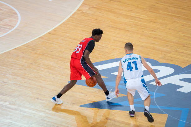 istock Basketball players chasing for ball 1289707408