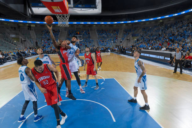 istock Basketball player jumping to score slam dunk 1289707427
