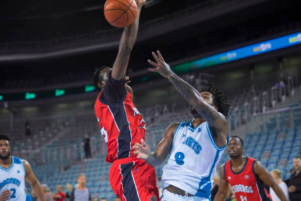 istock Basketball players chasing for ball 1289707457