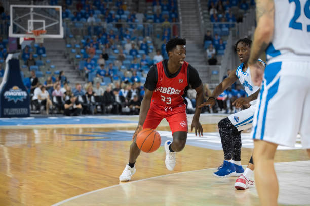 istock Basketball players chasing for ball 1289707491