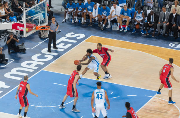istock Basketball players chasing for ball 1289707514
