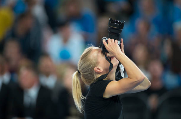 Close-up of sports photographer Close-up of female sports photographer photographing with camera. sports photography stock pictures, royalty-free photos & images