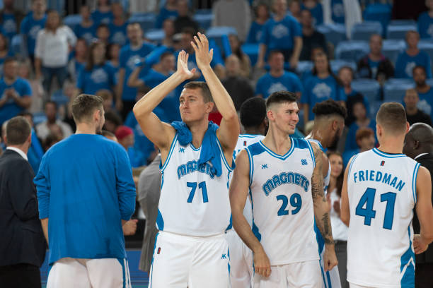 istock Basketball players standing on court 1289707533