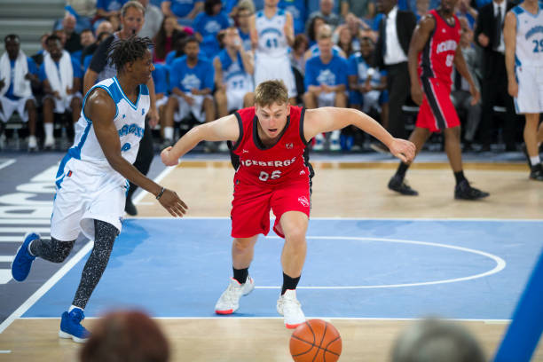 istock Basketball players chasing for ball 1289707568