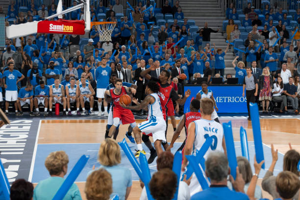 istock Basketball players chasing for ball 1289707572