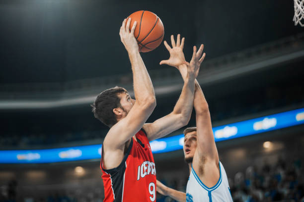 istock Basketball players chasing for ball 1289707576