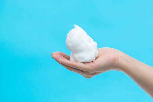 istock Foam bubble on woman hand 1289708379