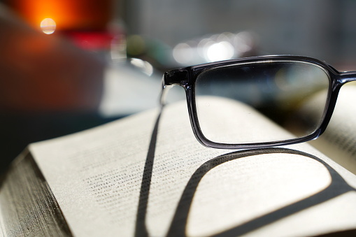 reading glasses standing on the book