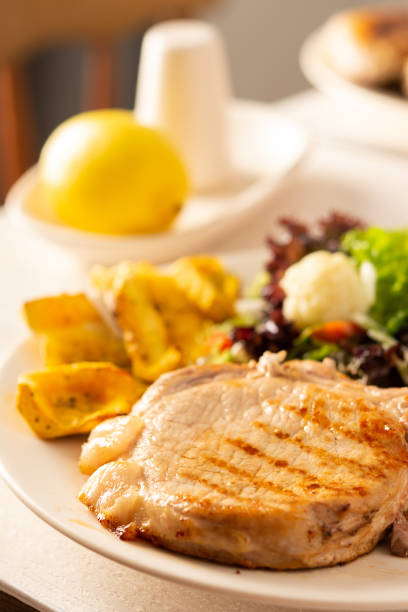 istock Pork entrecote on the bone with pumpkin and salad 1289708431