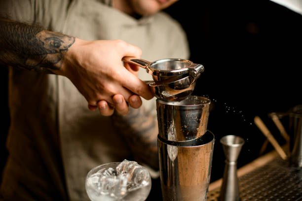 istock Barman holds steel squeezer and squeezes juice into shaker 1289708758