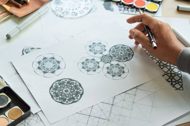 istock Designer designing drawing sketch pattern geometric flower seamless wallpaper fabric textile fashion industry. artistic design studio. 1289709412