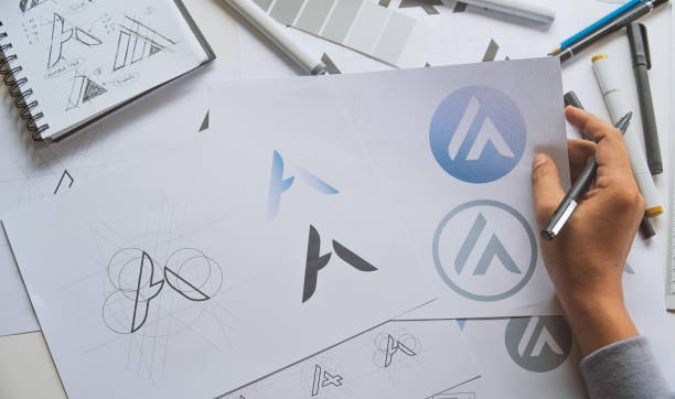 istock Graphic designer drawing sketch design creative Ideas draft Logo product trademark label brand artwork. Graphic designer studio Concept. 1289709419