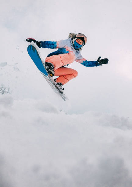 action shot of a young female on a snowboard - slalom skiing imagens e fotografias de stock