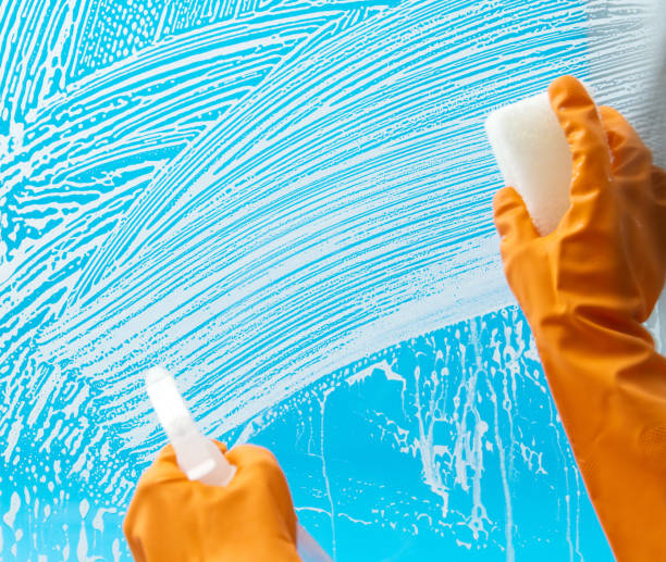 istock Cleaning glass window with sponge and spray bottle 1289711030