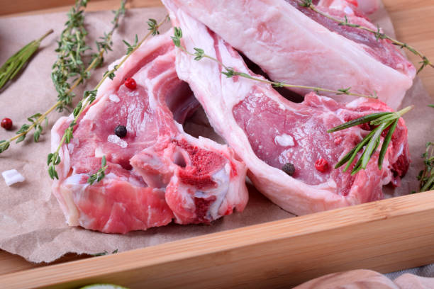 istock Raw lamb ribs, spices and herbs on parchment 1289711256