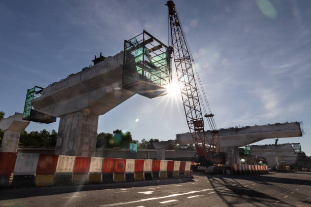 istock Silhouette with morning sun rays on highway overpass bridge infrastructure under construction 1289711937