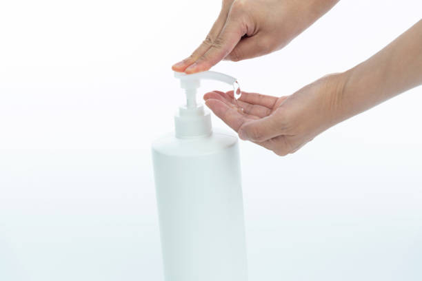 istock Woman clean hands with hand sanitizer on white background 1289712124