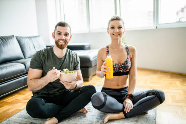 istock Fit couple eating snack after intensive home workout 1289712231