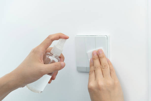 istock Woman hand wiping the light switch 1289712748