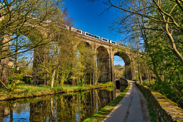 istock Arches of Saddleworth railway viaduct with train passing over, Uppermill, Saddleworth, Oldham, Greater Manchester, England, Britain 1289713518