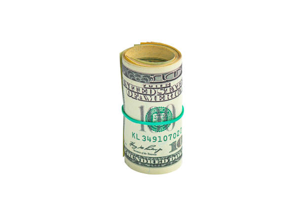 istock Roll of dollar bills tied with elastic band isolated on white background. 1289714162