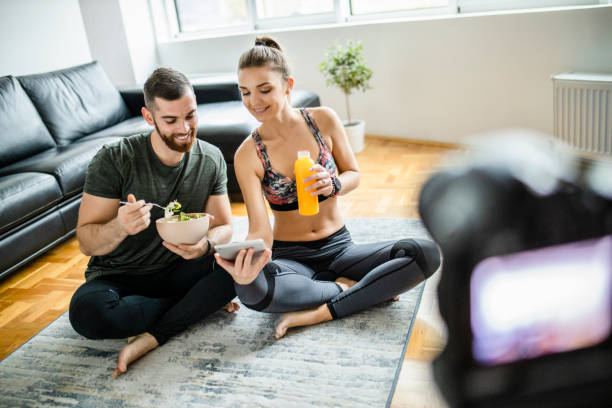 istock Young fit couple recording video tutorial session of healthy lifestyle 1289715420