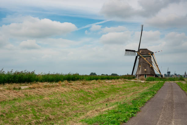 mill and cycling path in groot ammers, the netherlands - alblasserwaard imagens e fotografias de stock