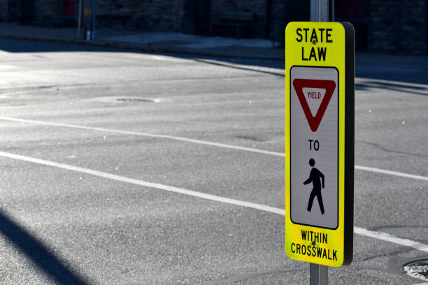 Pedestrian State Law Sign in Crosswalk, Horizontal Pennsylvania Pedestrian State Law Sign in Crosswalk. Safety yield sign in Conshohocken, PA a suburb of Philadelphia. yield sign photos stock pictures, royalty-free photos & images