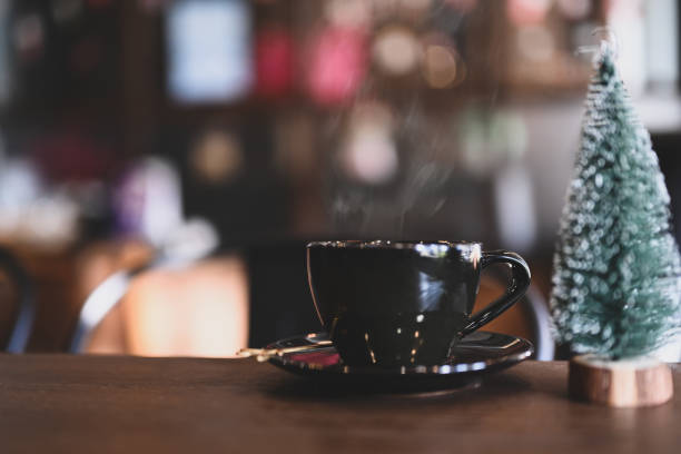 istock A cup of coffee or tea  and Christmas tree on wooden table. 1289719724