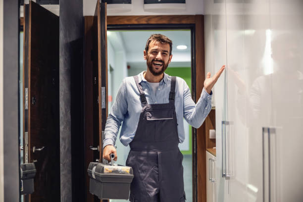 Nurse sitting at home, holding syringe with cure and giving advices over internet. Smiling friendly repairman entering the house, holding box with tools and he is ready to fix stuff in house. door repairman men manual worker stock pictures, royalty-free photos & images
