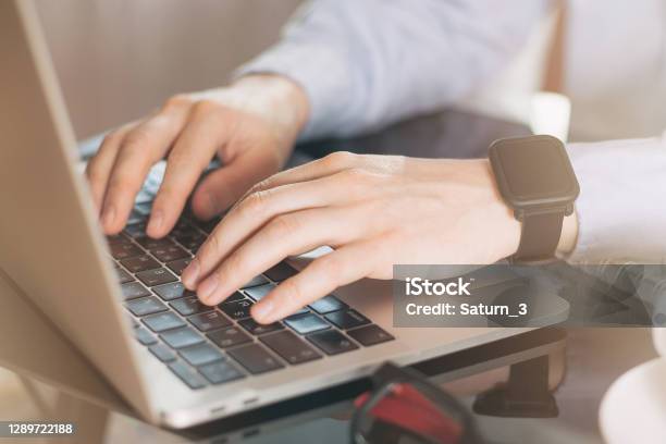 Cropped Image Of A Young Man Working On His Laptop Man Hands Busy Using Laptop At Office Desk Young Male Student Typing On Computer Sitting At Black Table Young Businessman Working With Laptop At Office Stock Photo - Download Image Now