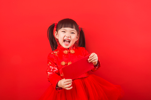 A Chinese girl celebrates Chinese New Year with a red envelope