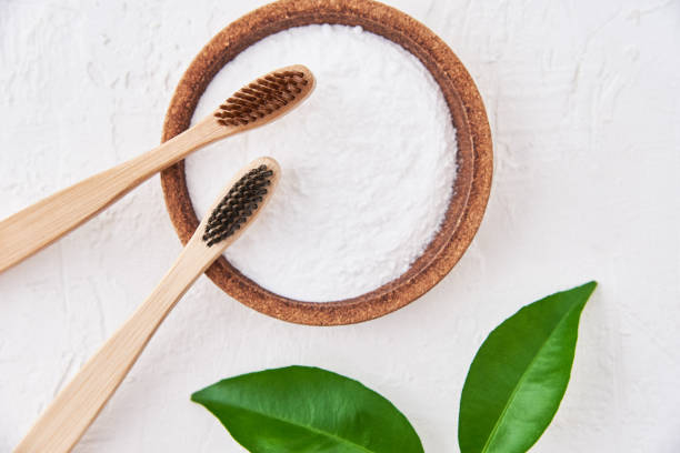 istock Two wooden bamboo toothbrushes and baking soda on white background, top view. Eco friendly toothbrushes, zero waste concept 1289729000