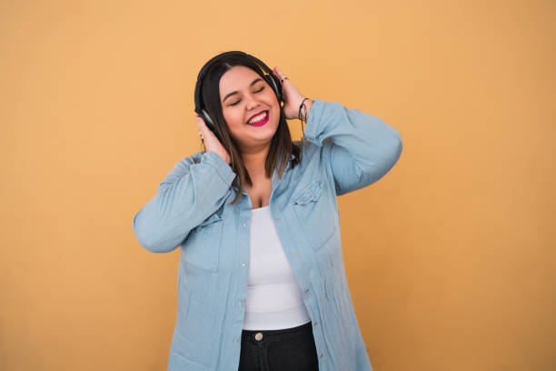 istock Woman listening to music with headphones 1289730388