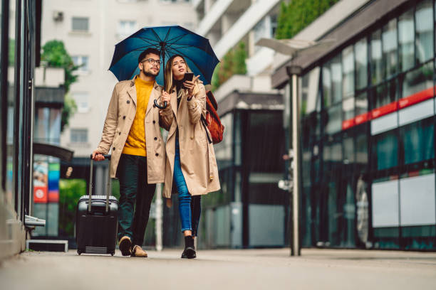 istock beautiful young couple walking in the rain 1289732902