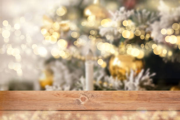 istock Empty wooden table top and blurred bokeh Christmas tree on the background. 1289733055