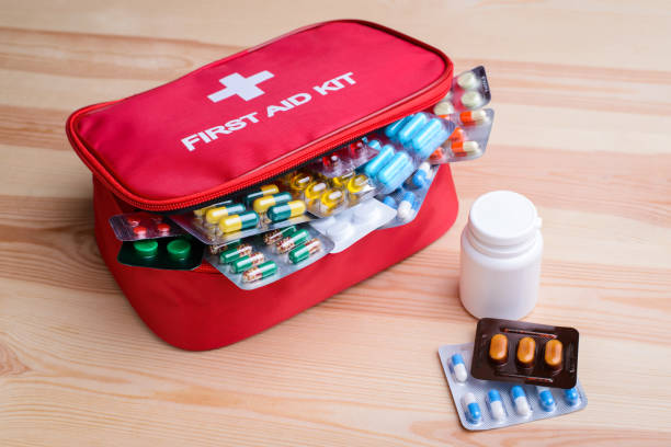 istock First aid kit with colorful capsules and pills on table. 1289733132