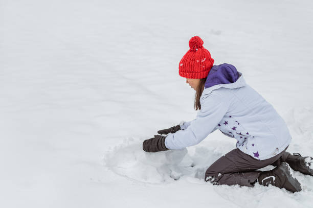 istock Young girl playing or making a snowman in a winter time 1289733200