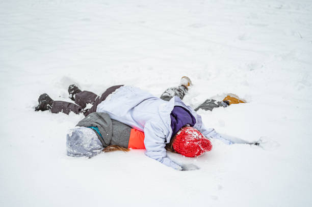 istock Two girls lying one over another in snow 1289733264