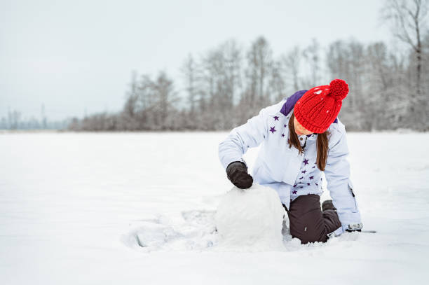 istock Young girl playing on a snow 1289734333