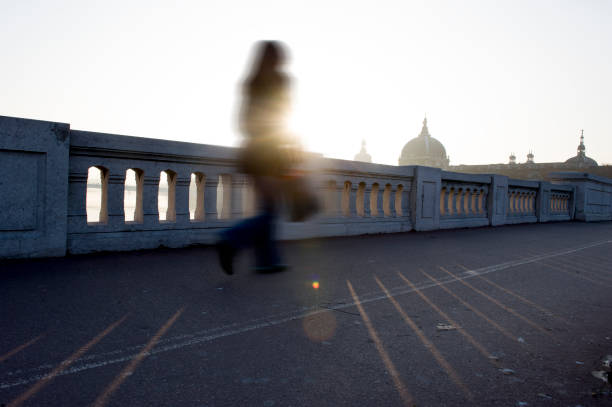 istock blurry woman in backlight on a city bridge 1289736101