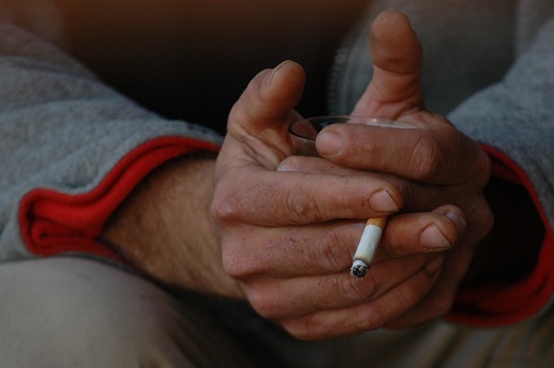 Close up on man Man extinguishes the cigarette in the ash tray quitting no smoking lung health problems